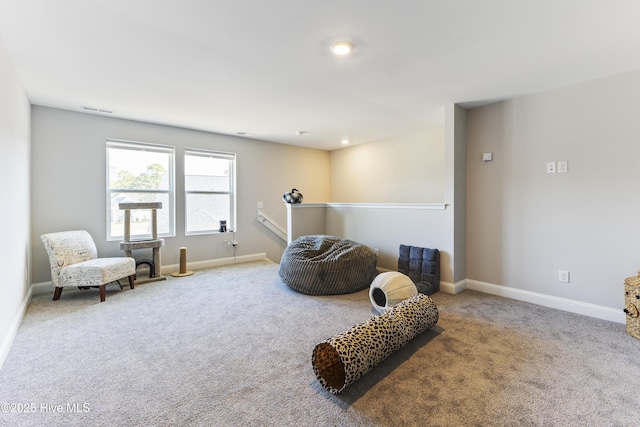 sitting room featuring carpet flooring, visible vents, and baseboards