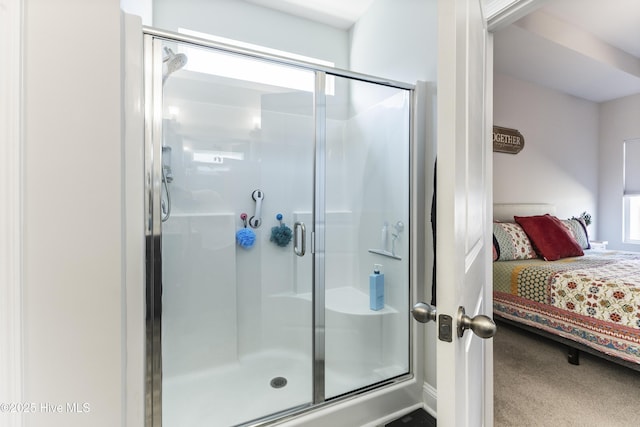 bathroom with ensuite bathroom, a stall shower, and a wealth of natural light