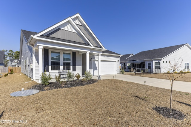 view of front of property with driveway, an attached garage, and fence