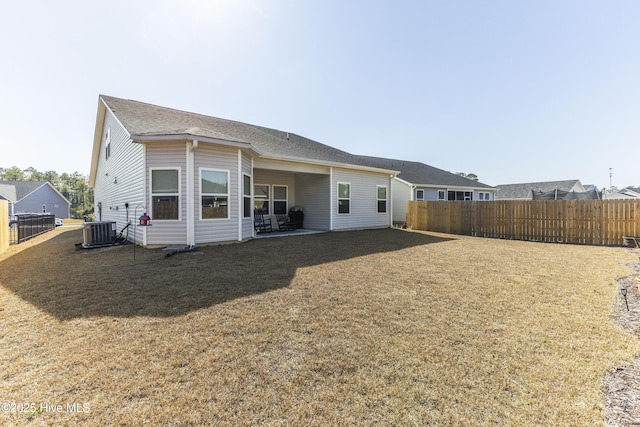 back of house with a yard, cooling unit, a patio area, and fence