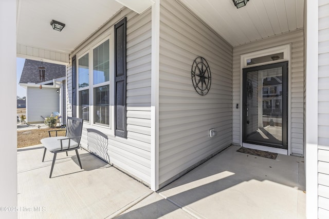 view of exterior entry with a porch