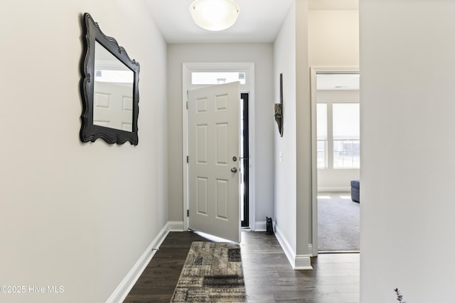 entryway featuring dark wood finished floors and baseboards