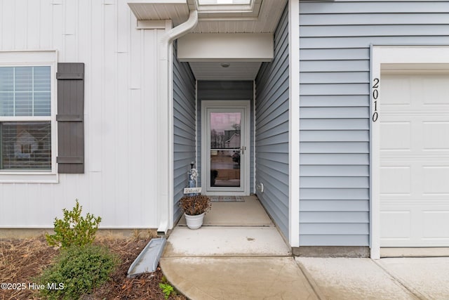 doorway to property featuring an attached garage