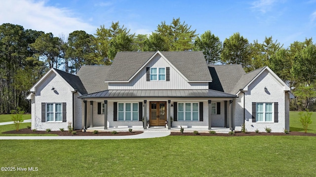 view of front of house featuring covered porch, brick siding, a standing seam roof, and a front yard