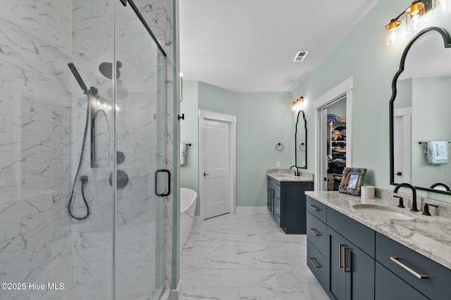 full bathroom featuring marble finish floor, a spacious closet, a sink, and a marble finish shower