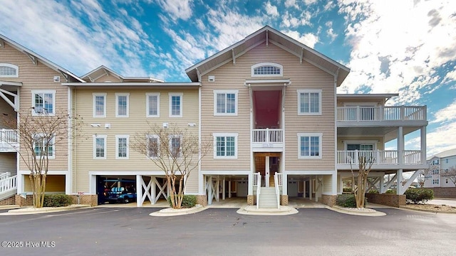 view of building exterior featuring a carport and driveway