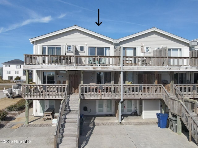 rear view of property featuring a patio area and stairs