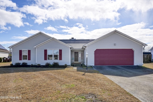 ranch-style home with a front lawn, an attached garage, and driveway