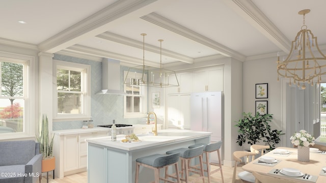 bar with wall chimney range hood, a healthy amount of sunlight, and an inviting chandelier