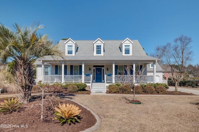 cape cod house featuring a porch