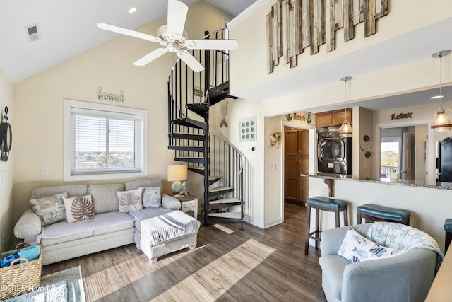 886 New River Inlet Rd Unit 41, North Topsail Beach, NC 28460 - living room with plenty of natural light, ceiling fan, stairway, estacked washer and dryer, and high vaulted ceiling