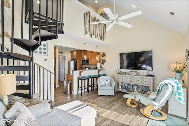 886 New River Inlet Rd Unit 41, North Topsail Beach, NC 28460 - living area featuring stairs, high vaulted ceiling, ceiling fan, and wood finished floors