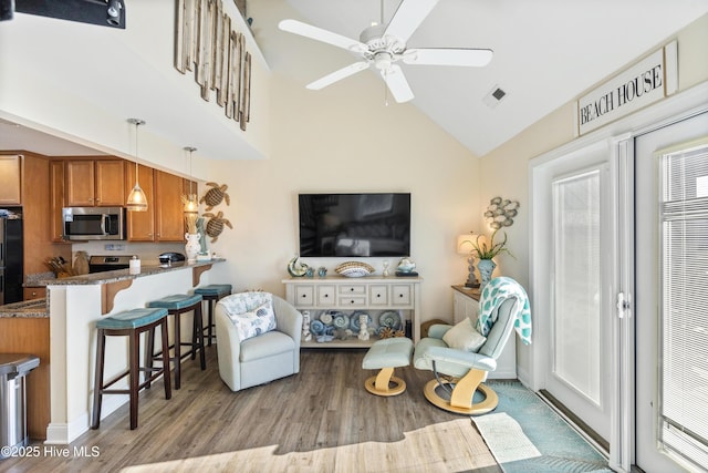 886 New River Inlet Rd Unit 41, North Topsail Beach, NC 28460 - living area featuring light wood-style flooring, ceiling fan, and high vaulted ceiling