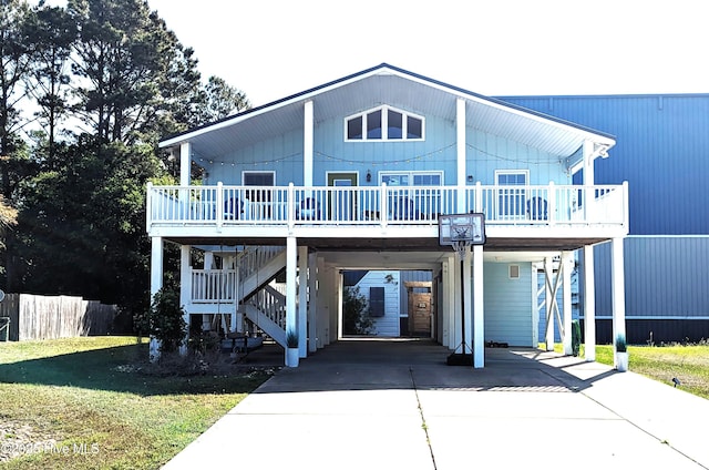 2029 Whispering Pine St SW, Ocean Isle Beach, NC 28469 - back of house with a wooden deck, a carport, driveway, and stairway