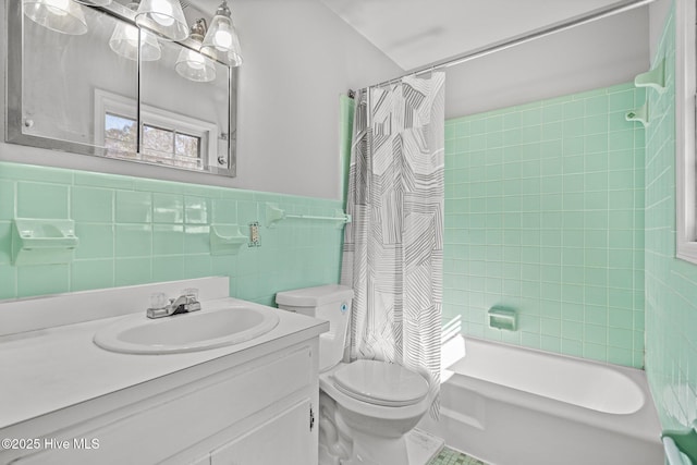 full bath with toilet, a wainscoted wall, tile walls, vanity, and shower / bathtub combination with curtain