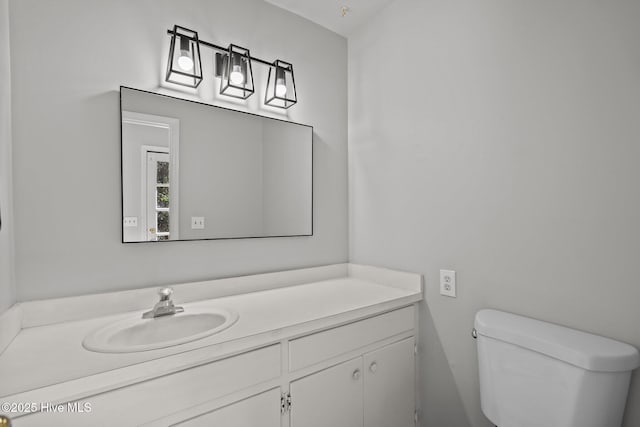 bathroom with toilet and vanity