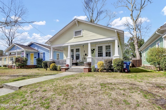 view of front of property with a porch and a front yard