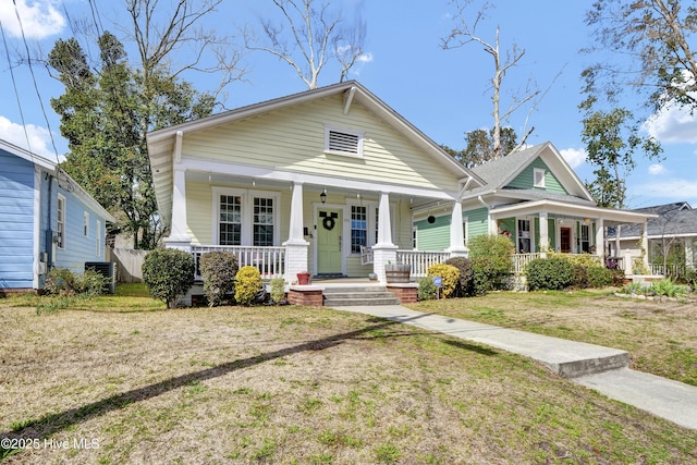 view of front of home featuring a porch, central AC, and a front yard