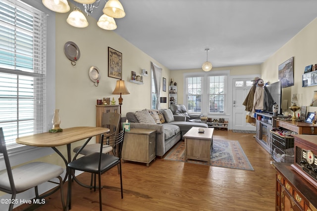 living area with a chandelier and wood finished floors