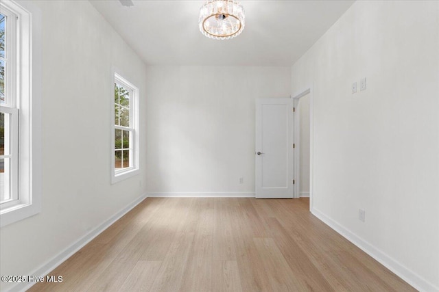 1708 Oakbrook Dr SW, Ocean Isle Beach, NC 28469 - spare room with light wood-style floors and a chandelier