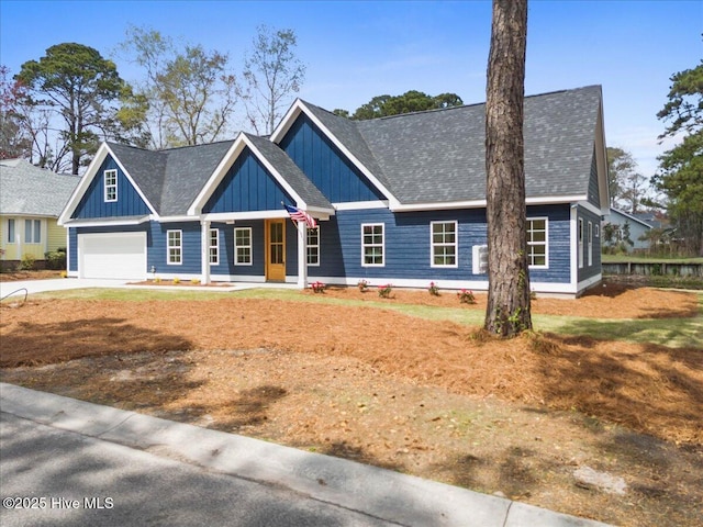 1708 Oakbrook Dr SW, Ocean Isle Beach, NC 28469 - view of front of home featuring board and batten siding, covered porch, concrete driveway, a garage, and roof with shingles