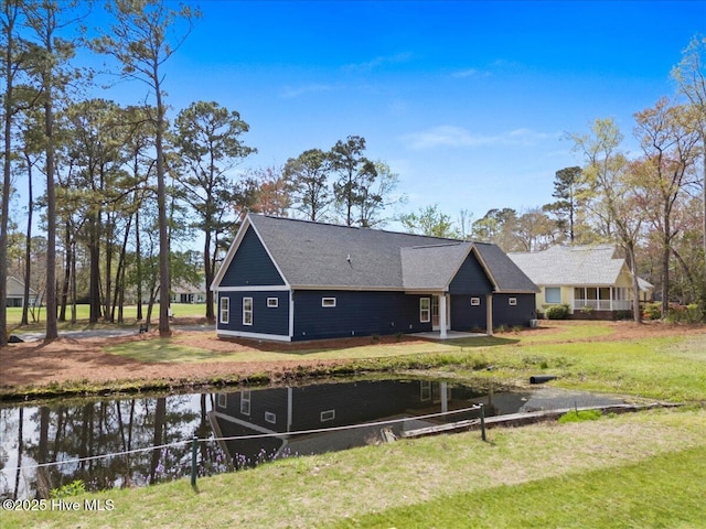 1708 Oakbrook Dr SW, Ocean Isle Beach, NC 28469 - rear view of house with a yard and a water view