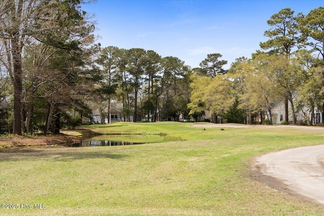 1708 Oakbrook Dr SW, Ocean Isle Beach, NC 28469 - view of community featuring a water view, a yard, and view of scattered trees