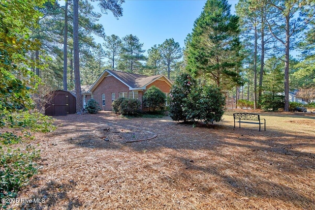 view of property exterior with a storage unit and an outdoor structure