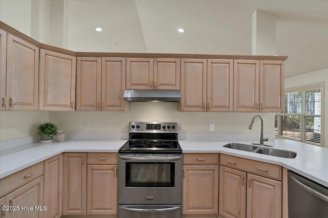 kitchen featuring stainless steel appliances, light countertops, light brown cabinetry, a sink, and under cabinet range hood