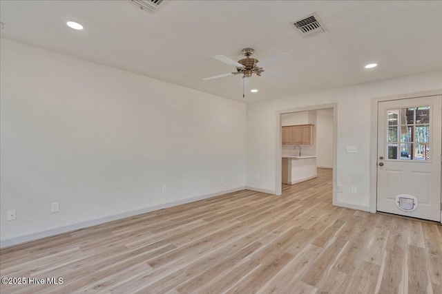 unfurnished room with recessed lighting, a sink, a ceiling fan, visible vents, and light wood finished floors