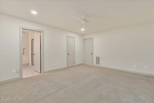 carpeted empty room with ceiling fan, visible vents, baseboards, and recessed lighting