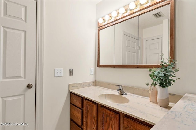 bathroom with visible vents and vanity