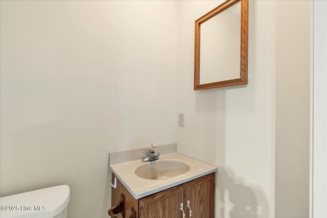 bathroom with toilet and vanity