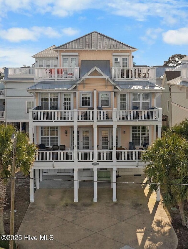 back of house featuring french doors and a balcony