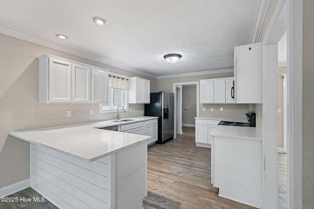 920 Shelter Creek Dr, Burgaw, NC 28425 - kitchen featuring a peninsula, stainless steel fridge, a sink, electric range oven, and ornamental molding