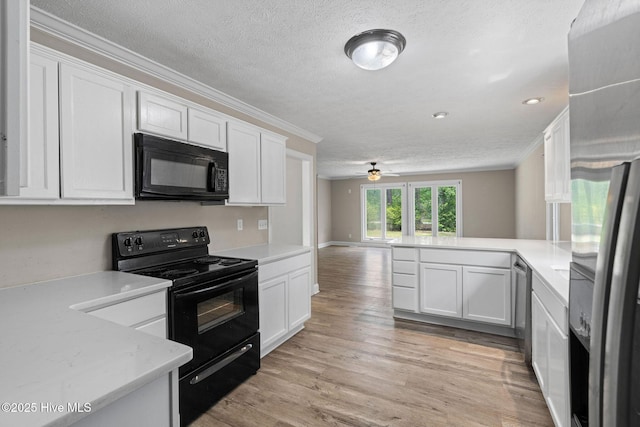 920 Shelter Creek Dr, Burgaw, NC 28425 - kitchen with a textured ceiling, white cabinetry, light countertops, and black appliances