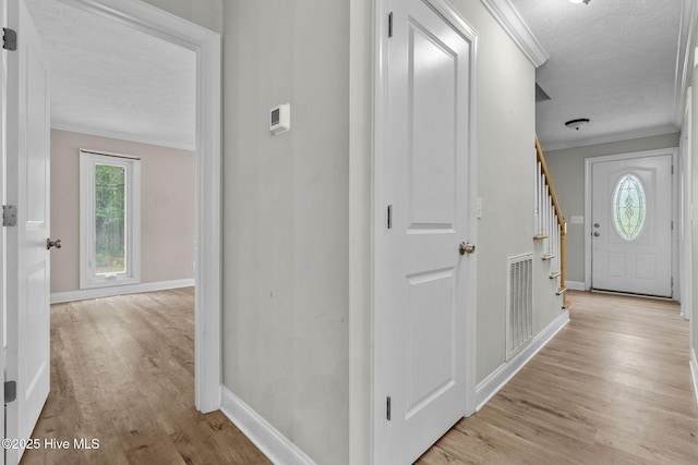 920 Shelter Creek Dr, Burgaw, NC 28425 - hall featuring a textured ceiling, baseboards, ornamental molding, visible vents, and light wood-style floors