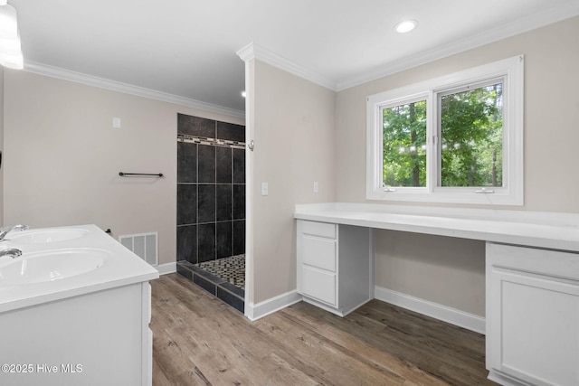 920 Shelter Creek Dr, Burgaw, NC 28425 - bathroom featuring a tile shower, ornamental molding, visible vents, and a sink
