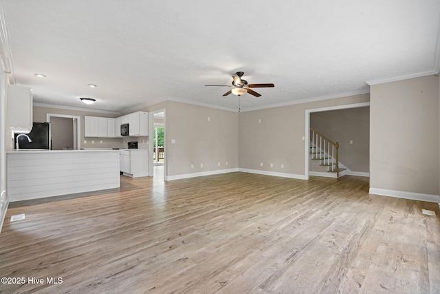 920 Shelter Creek Dr, Burgaw, NC 28425 - unfurnished living room with light wood-type flooring, baseboards, crown molding, and ceiling fan