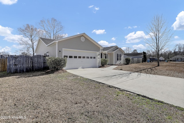 ranch-style house with a garage, driveway, fence, and a gate