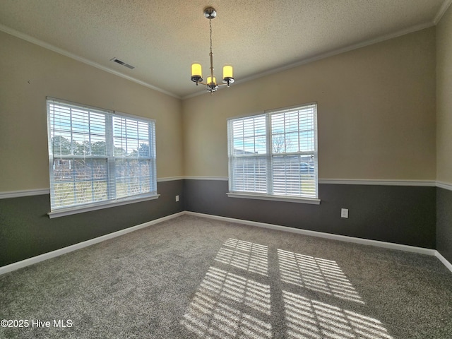 carpeted spare room featuring visible vents, an inviting chandelier, crown molding, and a healthy amount of sunlight