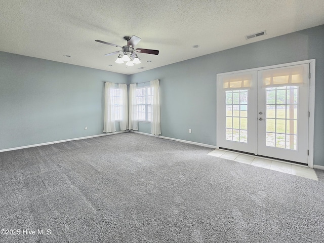 empty room featuring visible vents, carpet floors, baseboards, and french doors