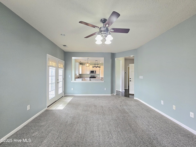 unfurnished living room with french doors, carpet floors, baseboards, and visible vents