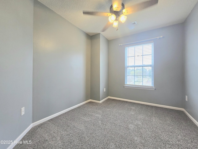 empty room with visible vents, a ceiling fan, a textured ceiling, carpet, and baseboards