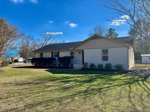 ranch-style home with brick siding and a front lawn