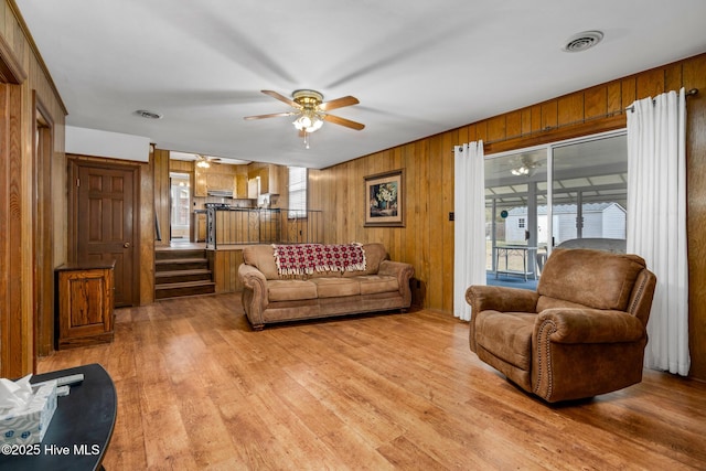 211 Brandon Ave, Tarboro, NC 27886 - living room with visible vents, ceiling fan, wooden walls, and light wood finished floors