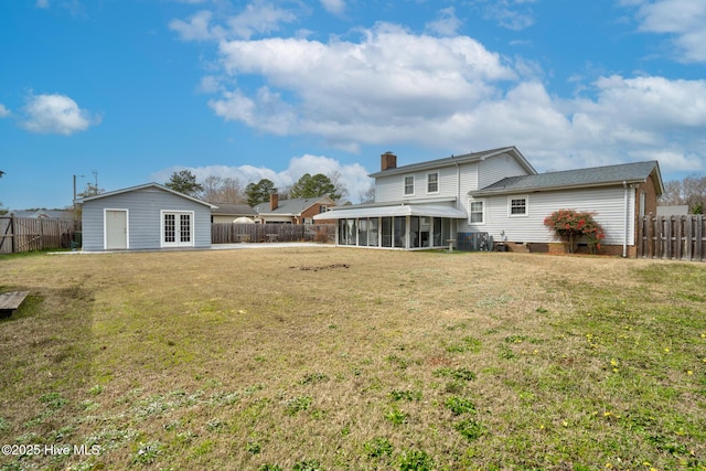 211 Brandon Ave, Tarboro, NC 27886 - back of house featuring french doors, a chimney, a lawn, a sunroom, and a fenced backyard