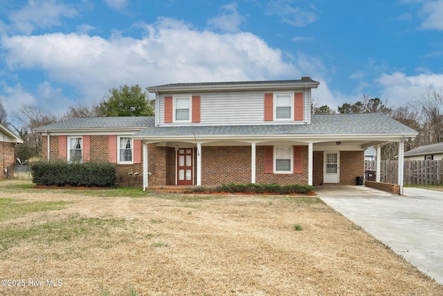 211 Brandon Ave, Tarboro, NC 27886 - view of front of home featuring concrete driveway, brick siding, a front yard, and fence