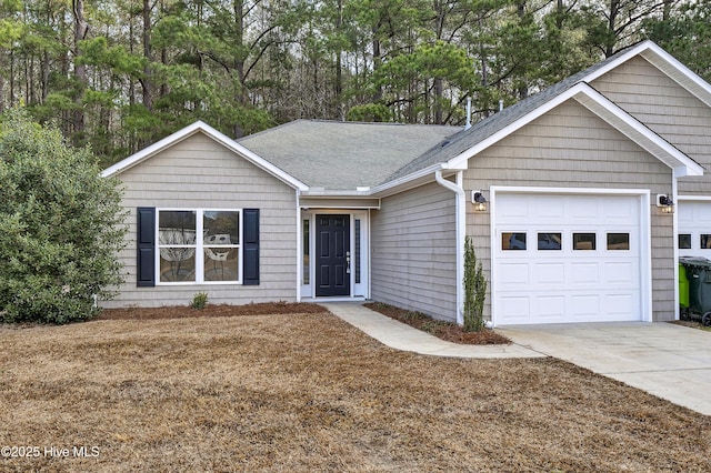 ranch-style house with an attached garage, driveway, and a shingled roof