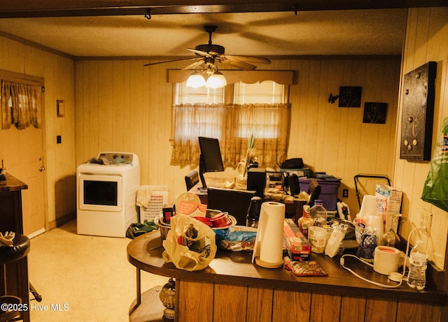 dining room with ceiling fan, washer / dryer, and light colored carpet